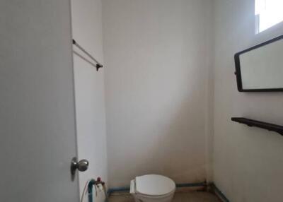 Small bathroom with a toilet and a mirror