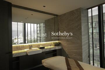 Modern bathroom with large window and marble finishes