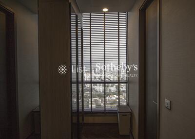 Room with blinds overlooking cityscape