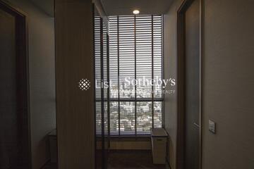 Room with blinds overlooking cityscape