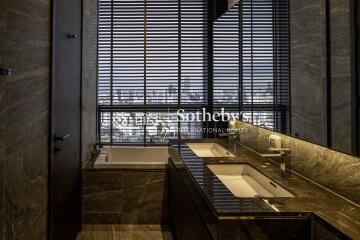 Luxurious bathroom with double sink and city view