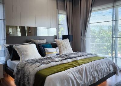 Modern bedroom with large windows and stylish decor