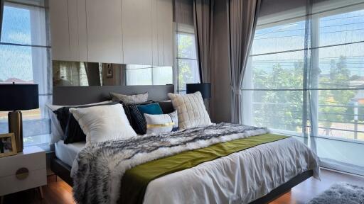 Modern bedroom with large windows and stylish decor