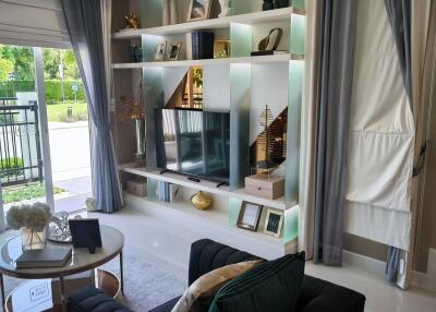 Modern living room with large window and built-in bookshelf