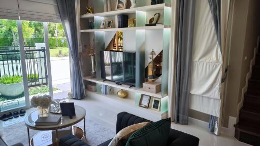 Modern living room with large window and built-in bookshelf