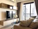 Modern living room with TV, sofa, and balcony