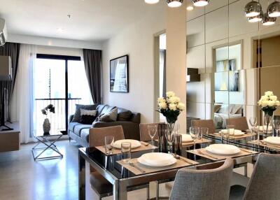 Modern living and dining area with a sofa, dining table, and decor