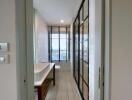 Modern bathroom with large window and glass partition