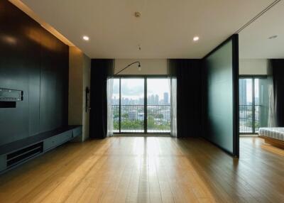 Spacious living area with large windows and city view