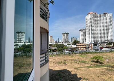 View from balcony showing cityscape with high-rise buildings