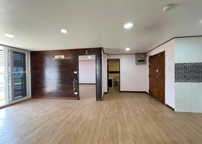 Spacious living room with wooden flooring and ample natural light