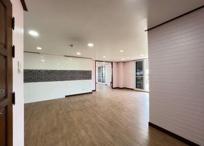 Spacious main living area with wooden floors and large windows