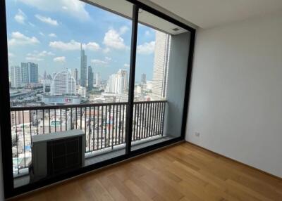 Spacious bedroom with large window and city view