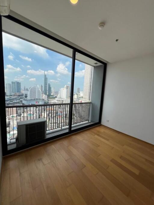 Spacious bedroom with large window and city view