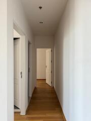 Narrow hallway with wooden flooring