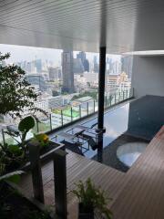 Luxury high-rise building with a rooftop swimming pool and city view