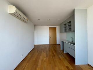 Modern kitchen area with wooden flooring