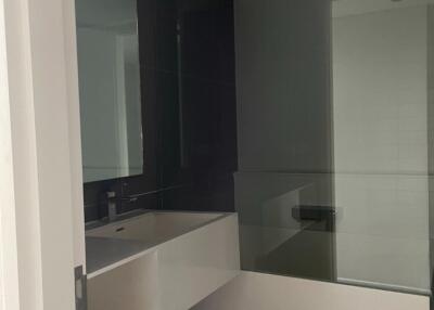 Modern bathroom with sink and glass shower partition