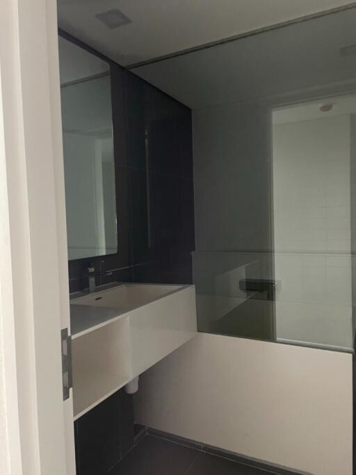 Modern bathroom with sink and glass shower partition