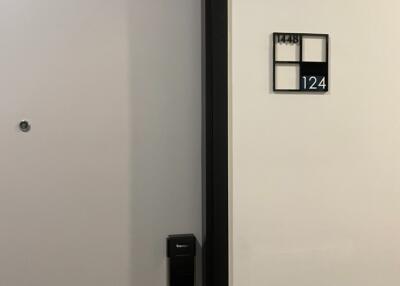 Apartment front door labeled 124 with electronic lock