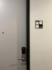 Apartment front door labeled 124 with electronic lock