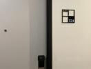 Apartment front door labeled 124 with electronic lock