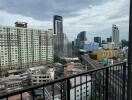 View from balcony overlooking cityscape with high-rise buildings