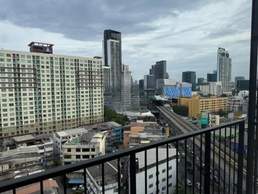 View from balcony overlooking cityscape with high-rise buildings