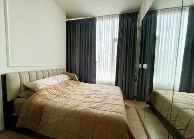 Bedroom with double bed and large windows