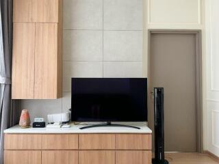 Living room with a TV and wooden cabinets