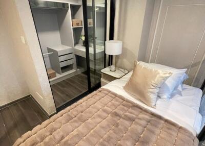 Cozy bedroom with a bed and a sliding mirrored wardrobe