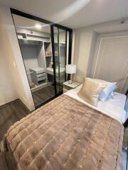 Cozy bedroom with a bed and a sliding mirrored wardrobe