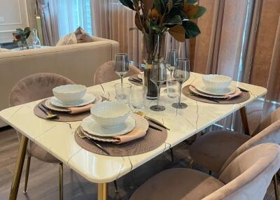 Elegant dining area with marble table and cushioned chairs