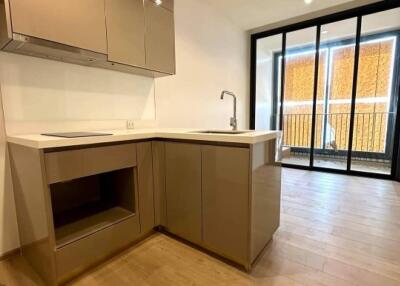 modern kitchen with brown cabinets and large sliding glass door