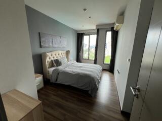 Modern bedroom with bed, windows, and wooden flooring