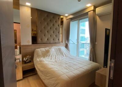 bedroom with bed, nightstands, and balcony view