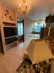 Spacious living room with chandelier and decorative items