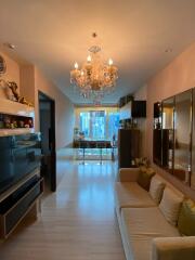 Elegant living room with chandelier and modern furnishings