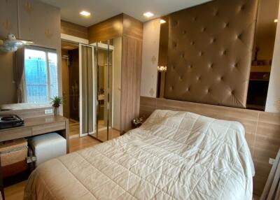 Modern bedroom with large bed, built-in closets, and natural lighting