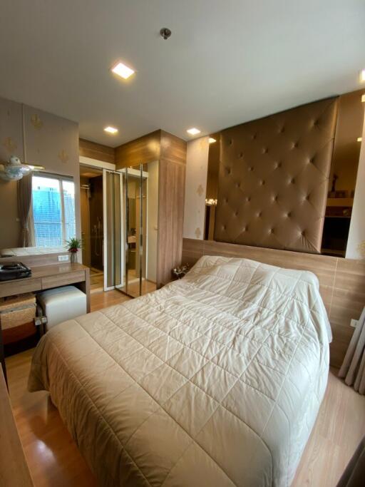 Modern bedroom with large bed, built-in closets, and natural lighting