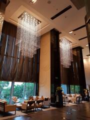 Luxurious lobby with modern chandelier lighting and seating area