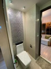 Modern bathroom with toilet and decorative wall