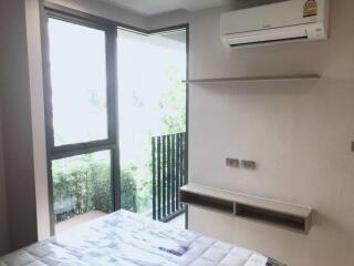 Bedroom with large window, balcony and air conditioning