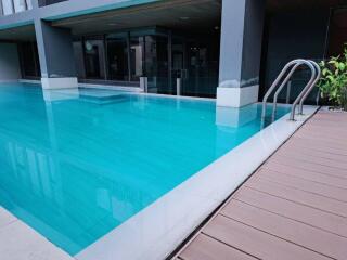 Outdoor swimming pool with surrounding deck