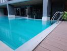 Outdoor swimming pool with surrounding deck