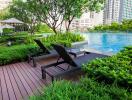 Outdoor pool area with lounge chairs and greenery