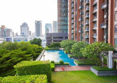 High-rise condominium with outdoor pool and garden area