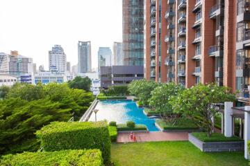 High-rise condominium with outdoor pool and garden area