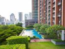 High-rise condominium with outdoor pool and garden area