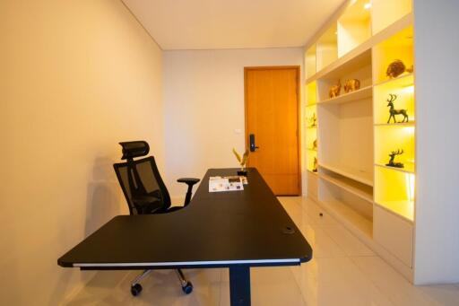 Modern home office with desk and bright shelving